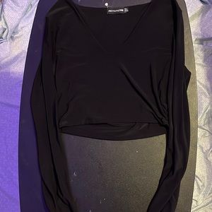 This is a black long sleeve crop top from pretty little things.